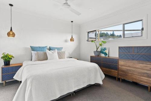 a bedroom with a large bed and a window at Blue Tide in Lennox Head