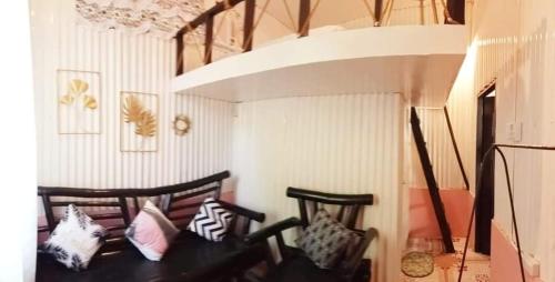 a room with two chairs with pillows on them at EDMUND's GARDEN INN in Siquijor
