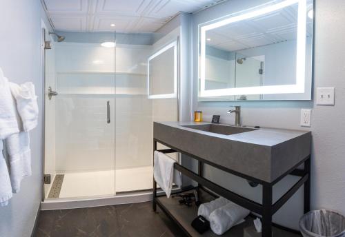 a bathroom with a sink and a shower at Terrace Bay Hotel - Lakefront in Escanaba