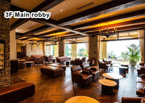 a large lobby with couches and chairs and tables at La Vista Kirishima Hills in Kirishima