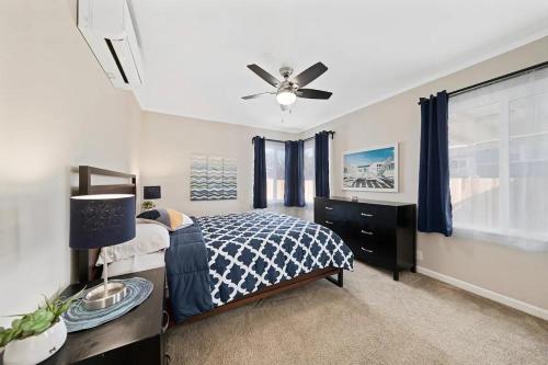 a bedroom with a bed and a ceiling fan at Spacious Centrally Located NEW 2 Bedroom Property! in Inglewood