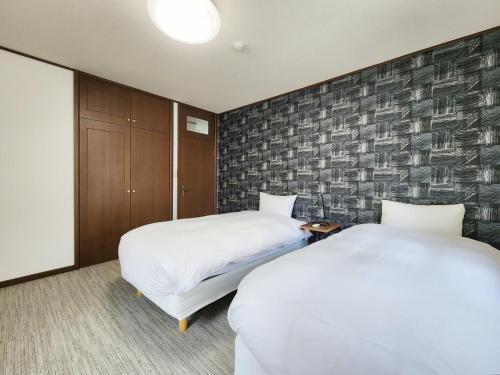 Postel nebo postele na pokoji v ubytování Hakuba Echoland Cottage by JAMSZ ROYALE
