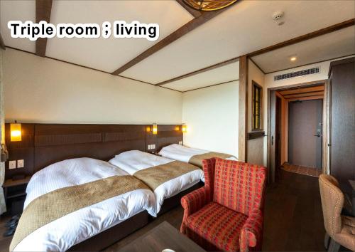 a hotel room with two beds and a chair at La Vista Kirishima Hills in Kirishima
