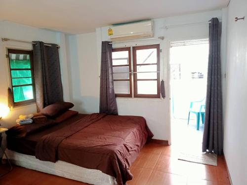 曼谷的住宿－年輕美麗旅館，一间卧室设有一张床和一个大窗户