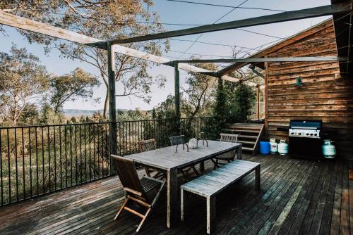 a wooden deck with a table and chairs and a grill at Ilkley House - A Refreshing Family Rural Getaway in Mudgee