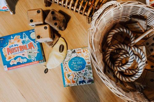 a table with a basket of food and a book at Ilkley House - A Refreshing Family Rural Getaway in Mudgee