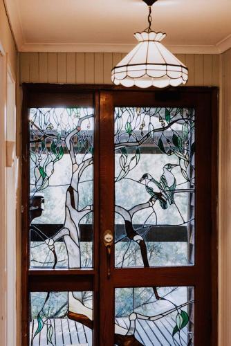 a door with a stained glass window in a room at Ilkley House - A Refreshing Family Rural Getaway in Mudgee