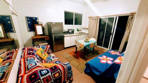 a kitchen with a couch and a table in a room at Barefoot Base Tupapa in Rarotonga
