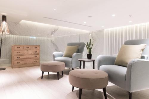 a waiting room with chairs and a dresser at Riverview Suites Taipei in Taipei