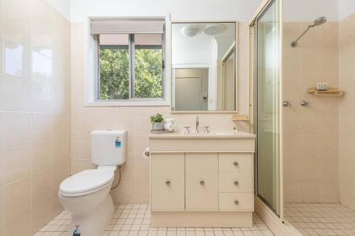 a bathroom with a toilet and a sink and a shower at Cundletown Cove in Cundletown