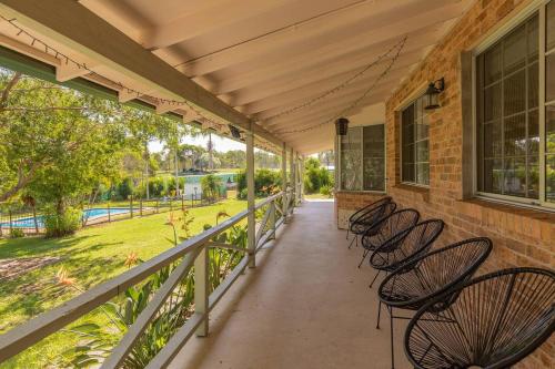 a row of chairs on the porch of a house at Cundletown Cove in Cundletown