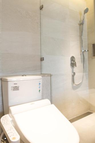 a bathroom with a toilet and a shower at Riverview Suites Taipei in Taipei