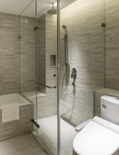 a bathroom with a shower and a toilet at Riverview Suites Taipei in Taipei