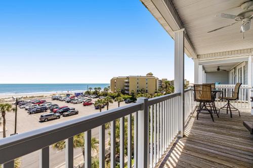 a balcony with a view of the beach and a parking lot at Pavilion Watch #3I in Folly Beach