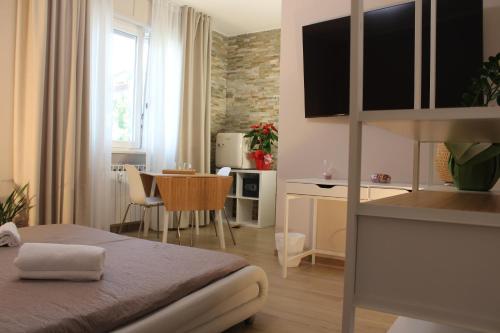 a bedroom with a bed and a dining room at Aurora BnB in Pisa
