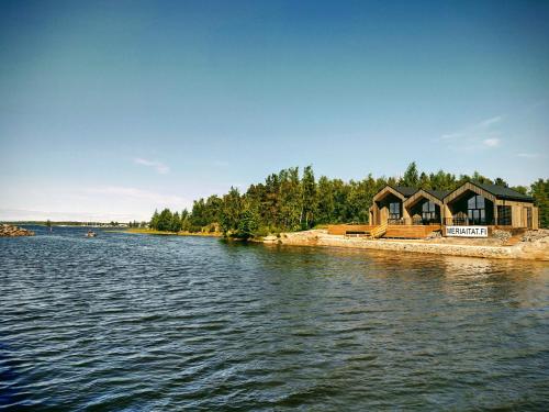 a house on the shore of a body of water at Meriaitat in Kokkola