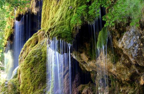a waterfall on the side of a cliff at Fischer`s Postresidenzen Ettal in Ettal
