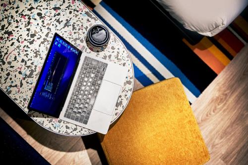 a table with a laptop computer on top of it at Aloft Osaka Dojima in Osaka