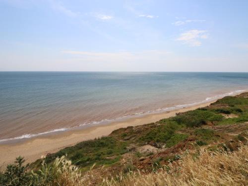 a view of the beach from a bluff at The Coach House in Newport