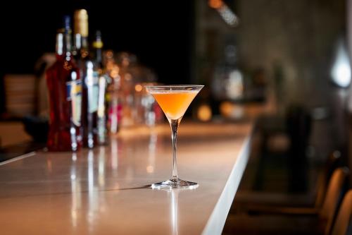 a drink in a martini glass sitting on a bar at Aloft Osaka Dojima in Osaka
