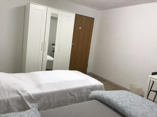 a bedroom with two beds and a mirror at Brahms 25 in Regensburg