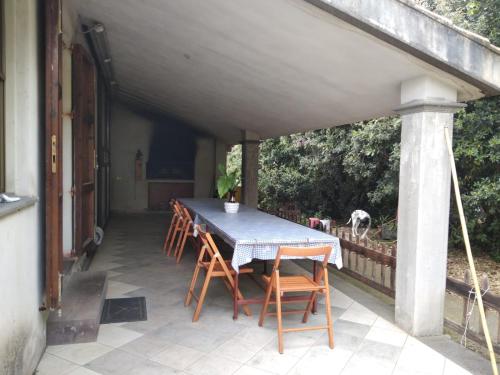 a table and chairs on a patio with a dog at Sardinia Ovest 2 in Putzu Idu