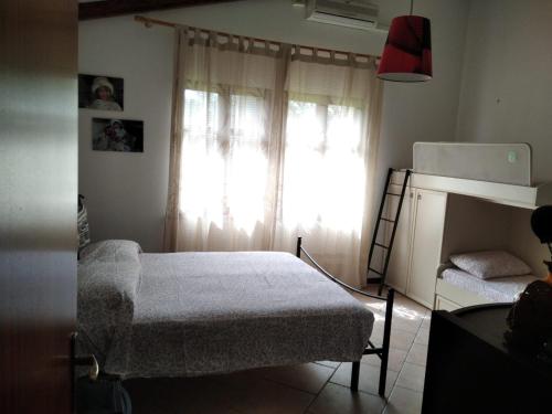 a small bedroom with a bed and a window at Sardinia Ovest 2 in Putzu Idu