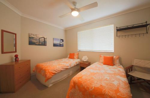 1 dormitorio con 2 camas y ventana en The Headland, en Woolgoolga