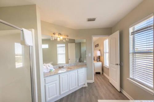 a bathroom with a sink and a mirror at The Herron, Sleep 20, Walk beach in Gulf Shores