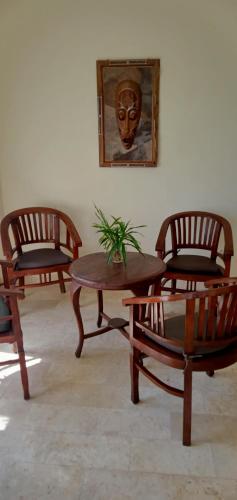 a group of chairs and a table with a plant on it at Secret garden villa 5 # 3 in Mangsit