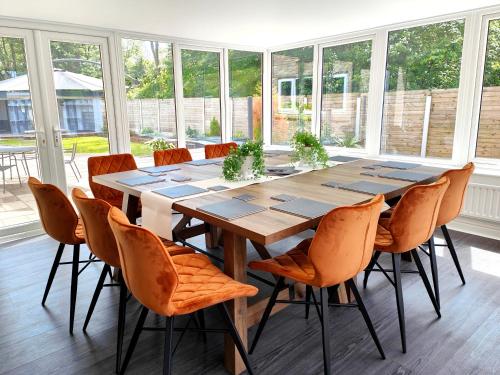 a dining room with a wooden table and chairs at Sanderson Park in Cleator Moor