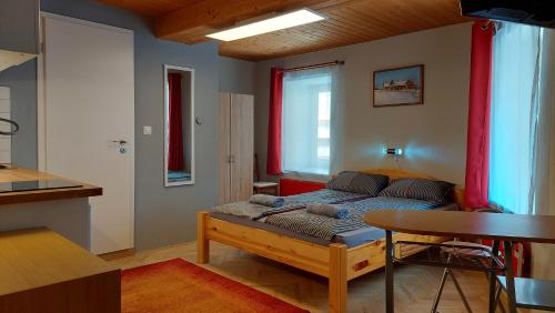 a bedroom with a bed and a table in a room at Das Eckhaus in Murau