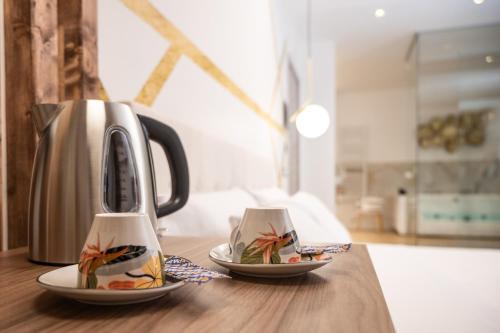 a tea kettle and two plates on a table at Civico 31 Luxury rooms in Castel San Giorgio