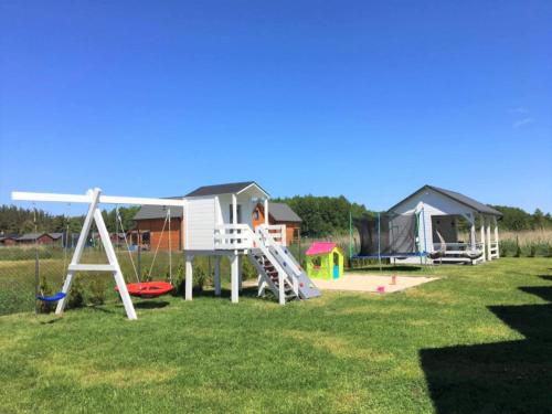 a playground with a slide and a house at Morska Mila in Kopań