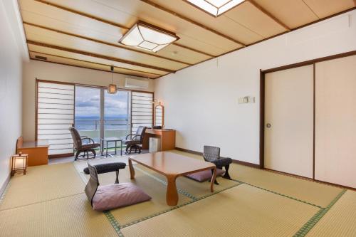 a living room with a table and chairs at Ibusuki Kaijo Hotel in Ibusuki