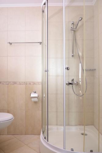 a shower with a glass door in a bathroom at House Diona in Sozopol