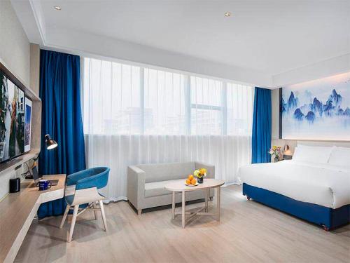 Ένα ή περισσότερα κρεβάτια σε δωμάτιο στο Kyriad Hotel Luoyang Longmen Railway Station