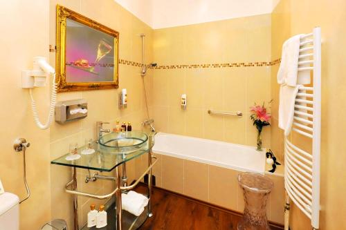 a bathroom with a tub and a glass table at Schlossgasthof in Artstetten