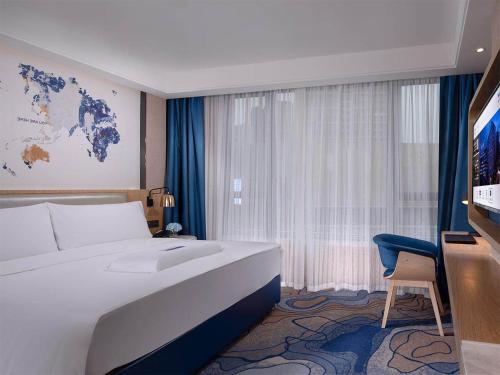 Ένα ή περισσότερα κρεβάτια σε δωμάτιο στο Kyriad Hotel Zhongshan University of Science and Technology