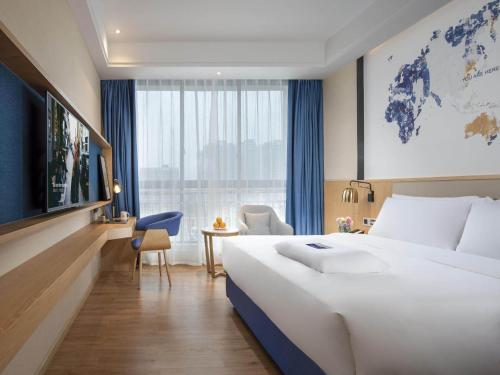 漢中的住宿－凯里亚德酒店(汉中高铁站店)，一间酒店客房,设有一张大床和一个大窗户