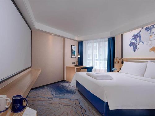 Ένα ή περισσότερα κρεβάτια σε δωμάτιο στο Kyriad Hotel Zhongshan University of Science and Technology