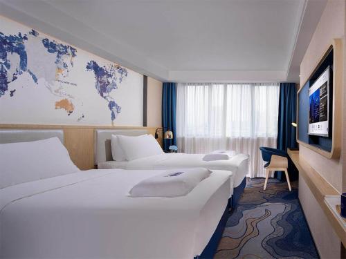 Ένα ή περισσότερα κρεβάτια σε δωμάτιο στο Kyriad Hotel Zhongshan University of Science and Technology