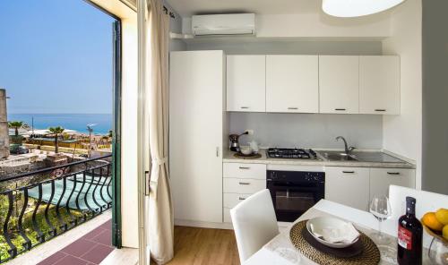 a kitchen with a view of the ocean at Appartamento Mare Marconi in Letojanni