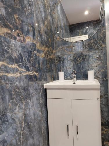 a bathroom with a sink and a mirror at OLGAS no2 HOUSE in Poligiros
