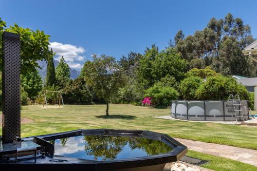 a swimming pool in a yard with a park at Hoogwater Family House in Wolseley