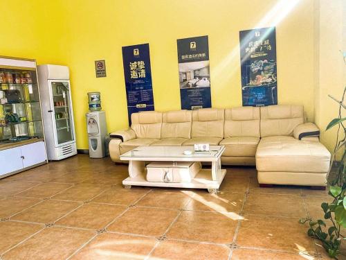 a living room with a couch and a coffee table at 7Days Inn Danyang Train Station Wuyue Square Branch in Zhenjiang