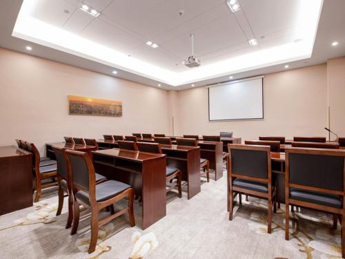 a conference room with tables and chairs and a whiteboard at Vienna SanHao Hotel Jiangsu Danyang Jinying in Danyang