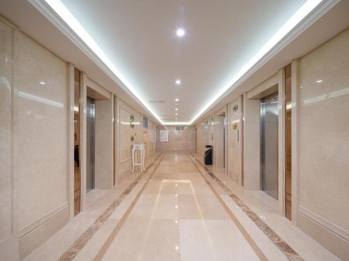 a hallway of a building with a long corridor at Vienna International Hotel Chongqing Yuanyangyuanboyuan in Chongqing