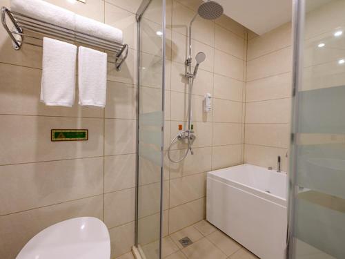 een badkamer met een douche, een toilet en een bad bij Vienna SanHao Hotel Jiangsu Danyang Jinying in Danyang