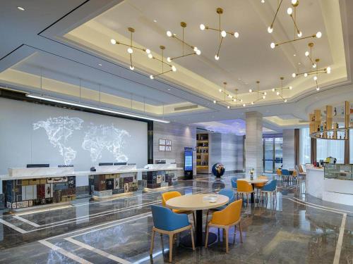 a large room with tables and chairs and a projection screen at Kyriad Marvelous Hotel Guilin Quanzhou in Quanzhou